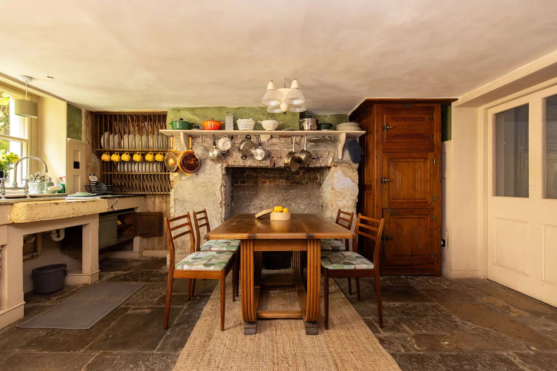 Rustic kitchen and dining area with stone fireplace