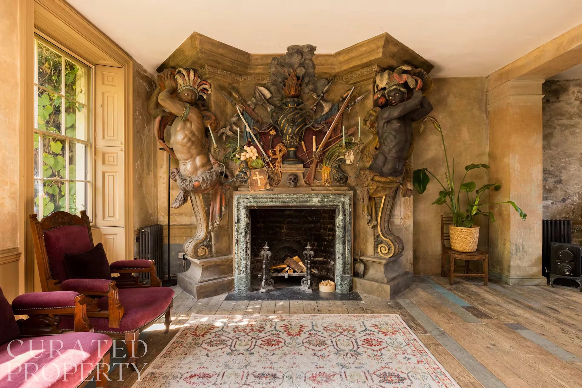 Living room with sculptural fireplace and velvet armchairs